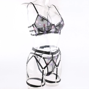 Detail of black mesh bra with pink fireworks floral embroidery and adjustable straps