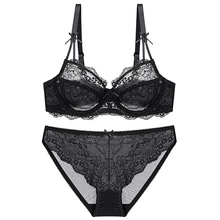 Flat lay of black floral lace lingerie set featuring underwire bra and matching panties