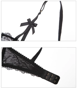 Detail of black lace bra set featuring bow shoulder straps and double hook-and-eye closure