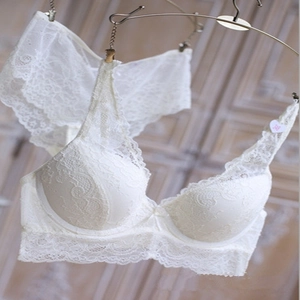 Detailed macro view of white floral lace lingerie set with underwire bra and matching panties