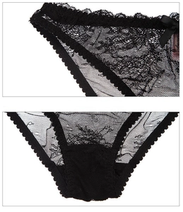 Macro detail of black floral lace panties with mesh and bow detail for women