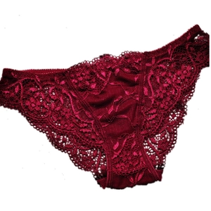 Detailed macro view of the wine red lace floral texture on low-waist women's panties