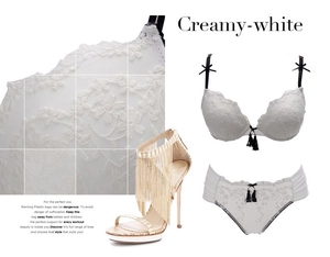 Detail of creamy-white floral lace lingerie set with black tassels and bow accents