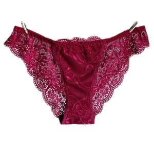 Detailed close-up of dark red luxury lace panties featuring intricate floral patterns