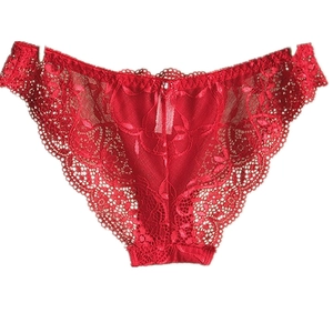 Detailed view of red luxury lace panties with semi-transparent floral patterns and scalloped edges