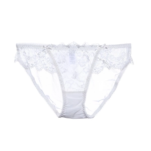 Détail d'une culotte en dentelle blanche avec nœuds latéraux et motif floral ajouré