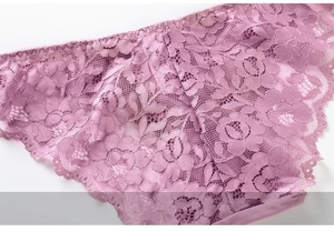 Close-up of elegant purple lace panties featuring exquisite floral patterns and scalloped edges