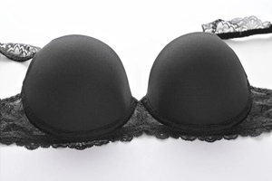 Close-up of black lace bra with smooth cups and detailed scalloped floral embroidery