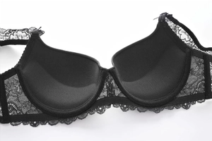 Detailed close-up showing the smooth inner cup lining and black floral lace of the bra