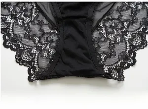 Detailed macro view of black lace panties with cotton crotch and eyelash trim
