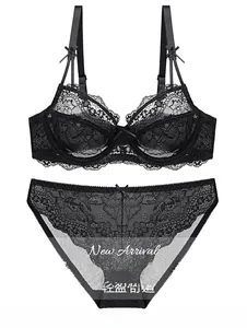 Detail view of black lace lingerie set with mesh fabric and delicate bow accents