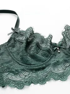 Nahaufnahme von dunkelgrünem Wimpernspitzen-BH mit Schleife und Strass-Anhänger-Detail