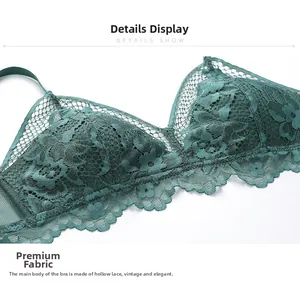 Detail of dark green lace bra showing intricate floral embroidery and wavy scalloped edges
