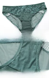 Close-up of dark green lace panties featuring floral embroidery and a cotton crotch