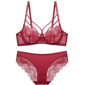 Red lace lingerie set with sheer floral bra and satin panty on white background
