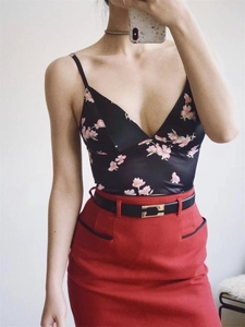 Macro detail of black floral satin camisole top with V-neck and delicate straps