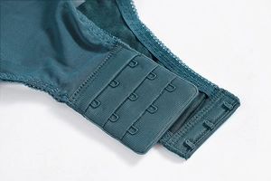 Detail view of the four-row hook-and-eye back closure on the mesh bodysuit in dark cyan