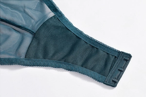 Detailed macro view of dark teal mesh wings and adjustable triple hook-and-eye closure