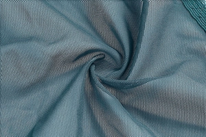 Close-up of breathable dark teal mesh fabric with fine diamond texture for shapewear