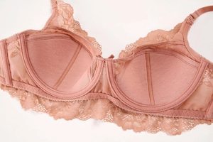 Detail view of lace bra with memory wire support and breathable mesh side wings