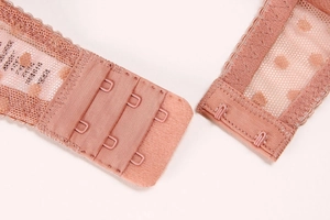 Detail view of the lace bra back closure with three-row two-hook metal fasteners