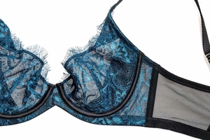 Detail of teal floral eyelash lace and black sheer mesh on a wire support bra