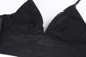 Detail of V-neck bralette with mesh lining and red floral patterned thin shoulder straps
