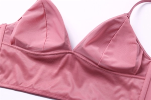Detailed close-up of pink mesh triangle bra with soft fabric texture and wide elastic band