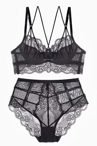Flat lay of black lace lingerie set with floral patterns and sheer mesh details