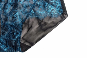 Close-up of blue floral lace and black mesh fabric with delicate eyelash trim detail