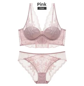 Detailed close-up of pink lace lingerie set featuring floral patterns and wide underband