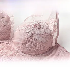 Close-up of pink lace embroidery with delicate floral patterns on breathable mesh fabric