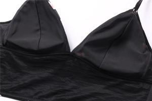 Detail view of black wireless satin bra with mesh panels and thin shoulder straps