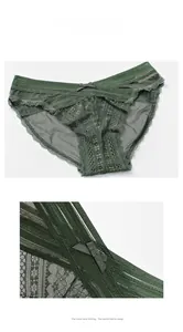Detail view of dark green lace panties with mesh panels and elegant bow decoration