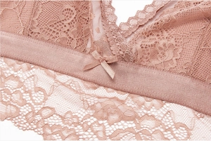 Close-up of delicate floral lace and satin bow on this rose pink V-neck wireless bralette