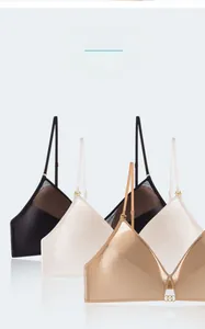 Three seamless wire-free triangle bras in black, white, and nude with mesh detailing