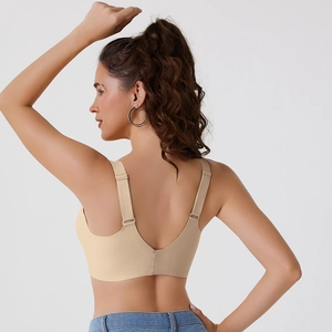 Detail of nude seamless wireless bra featuring wide adjustable straps and deep U-back
