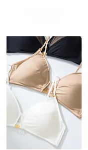 Macro shot of seamless wireless bras in black, beige and white with golden ring detail