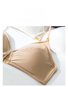 Macro shot of seamless wireless bras with mesh details and gold ring accents on straps
