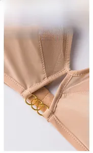 Detail view of nude wireless bra showing three gold rings and sheer mesh panels