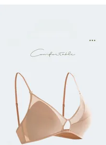 Detail view of seamless beige wireless bra with mesh patchwork and metal ring buckle