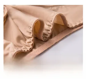 Detail of soft nude wireless bra fabric featuring seamless wavy edges and silky texture