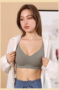 Detailed view of seamless grey-green bra styled with a casual white textured cardigan