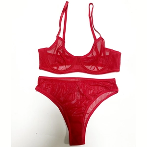 Detail shot of red sheer mesh lingerie set with adjustable straps and sizing label