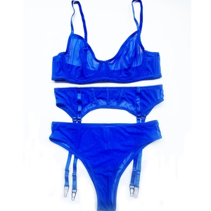 Detailed flat lay of cobalt blue mesh lingerie set with bra, garter belt and thong