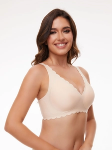 Detail of beige seamless bra featuring scalloped edges and wireless comfort design
