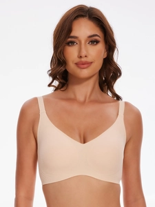Detailed view of seamless skin-tone wireless bra with wide straps and V-neckline comfort