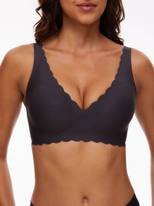 Detailed view of seamless charcoal grey bra featuring delicate scalloped edges and V-neckline