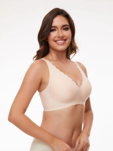 Detail of seamless skin-tone wireless bra with scallop edges and smooth fabric texture