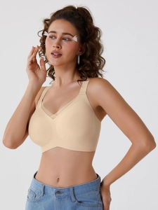 Side view of beige seamless wireless bra with V-shape mesh paneling on model